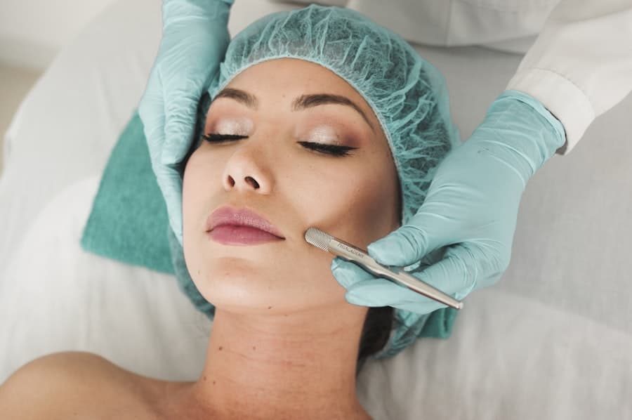 An esthetician performing a facial treatment